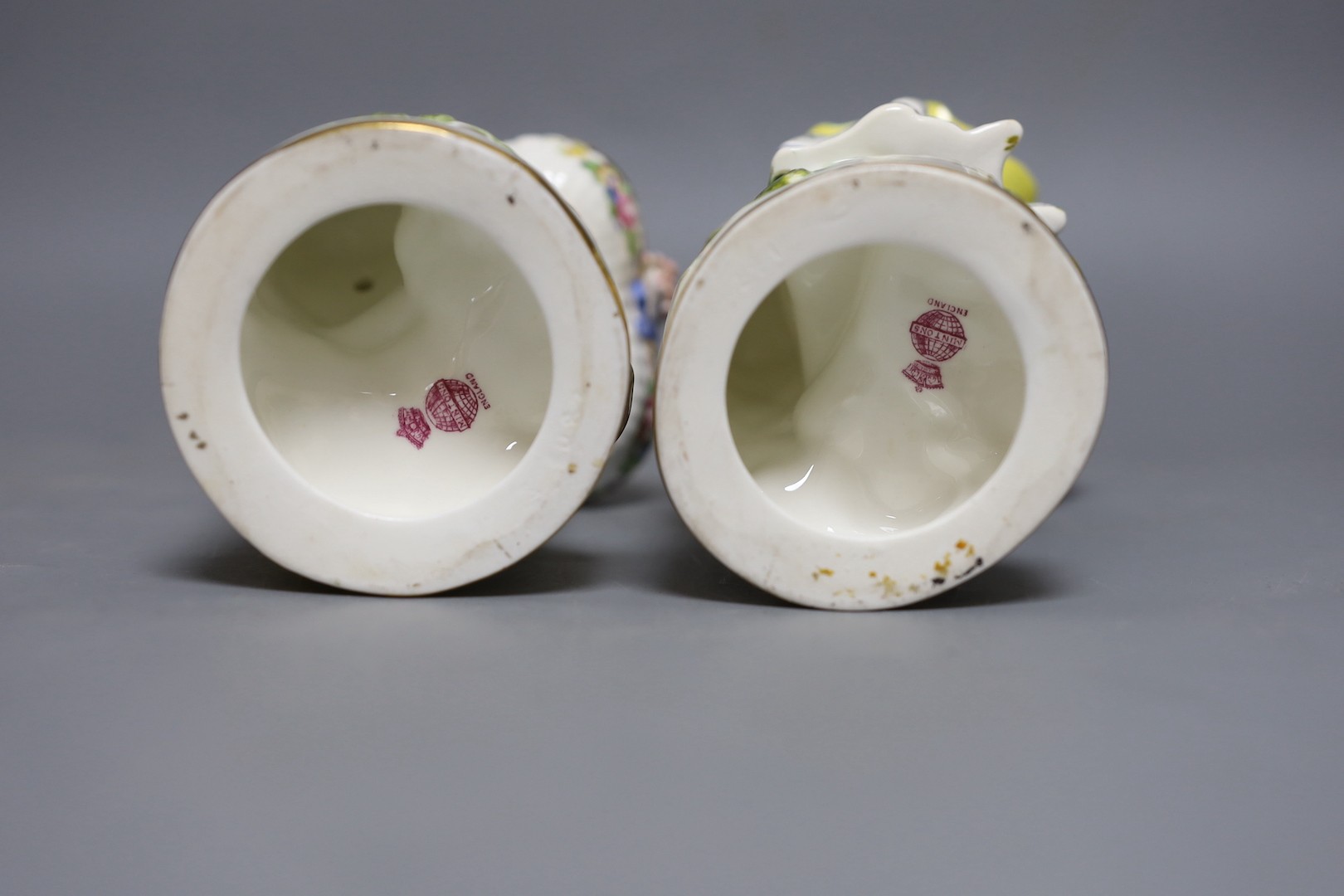 A pair of Victorian Minton's bone china figures holding baskets, 20cms high.